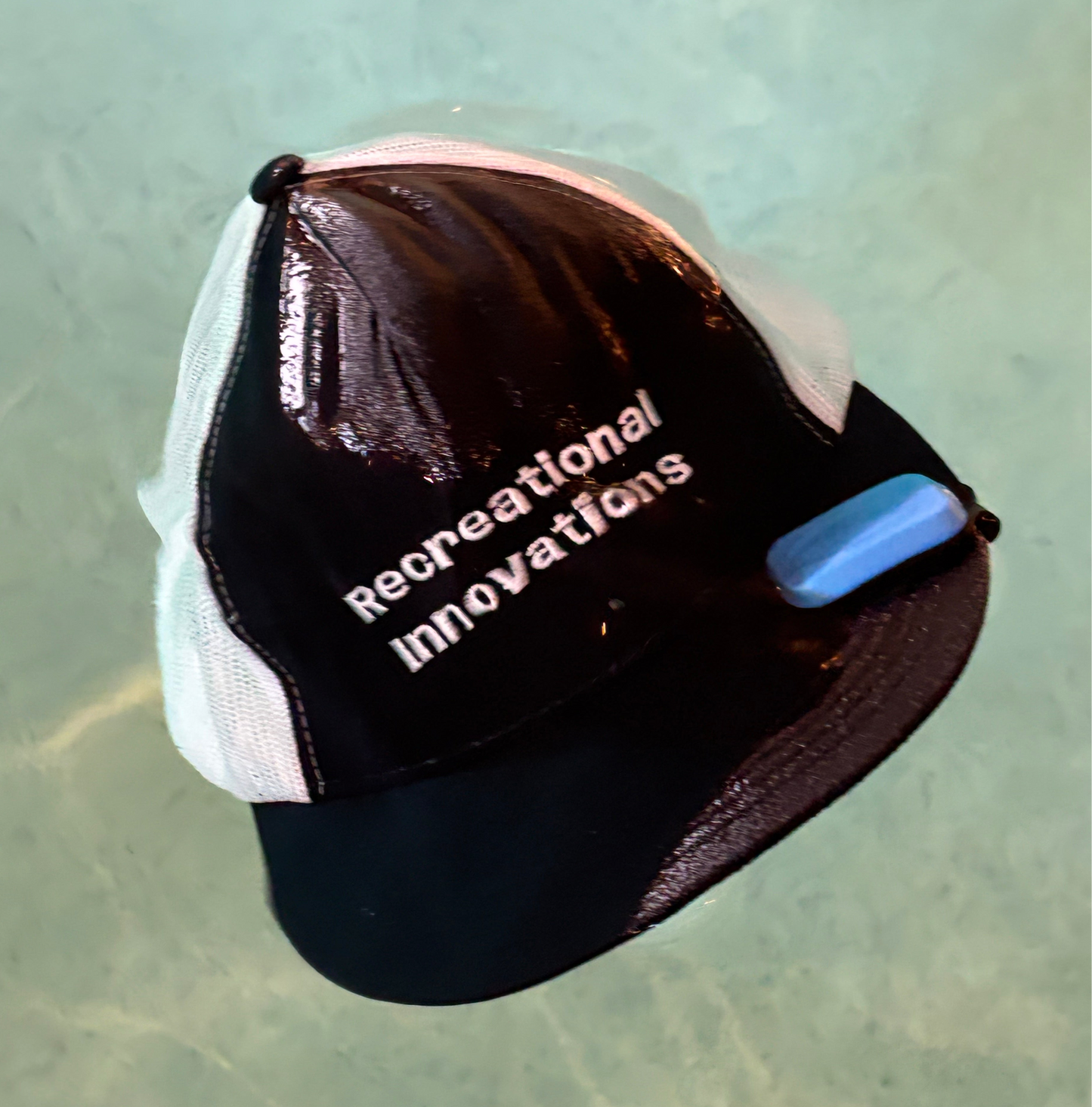 Recreational Innovations hat using the Billbobber hat float. Billbobber floating hat clip.