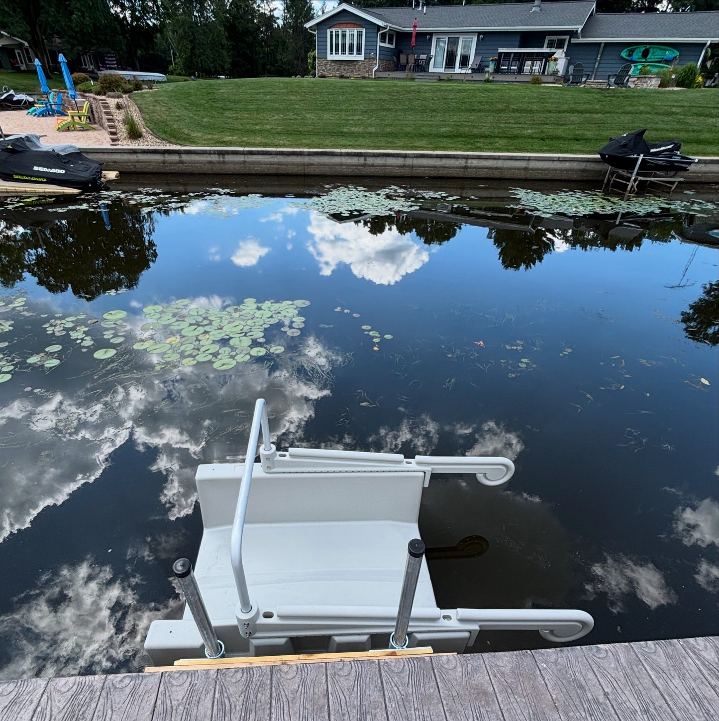 This gray YAKport is installed on a cement seawall using a fixed dock installation kit with 8' poles. Installed in Mauston,  Wisconsin at an Airbnb on Castle Rock Lake.